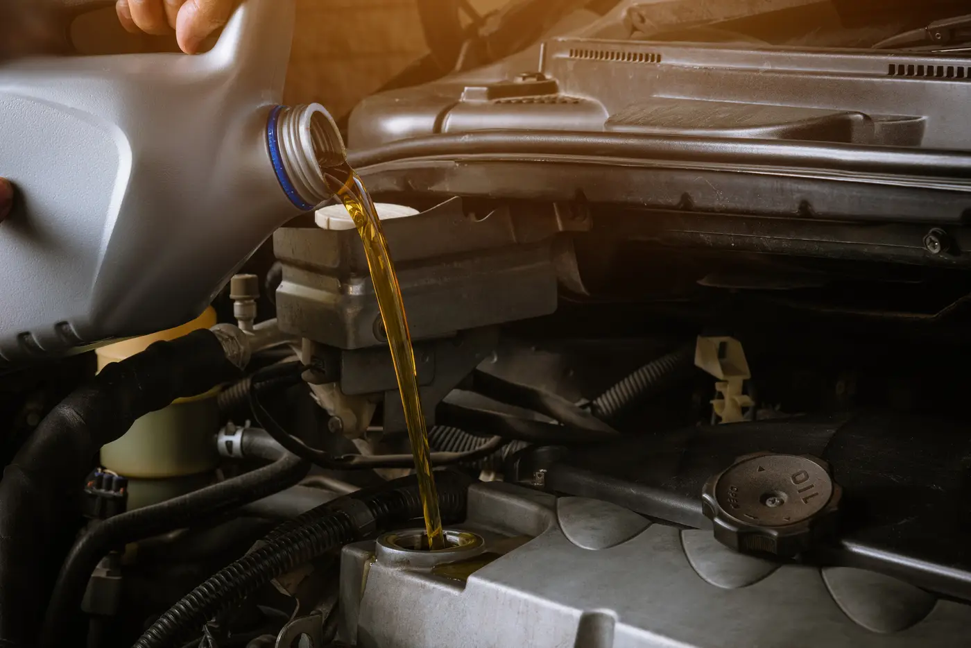 Premium engine oil being poured into an engine